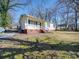 Front view of house with blue shutters and yard at 230 Spring Nw St, Concord, NC 28025