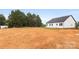 View of the backyard of a new home ready for landscaping and outdoor living at 244 Little Wilkesboro Rd, Harmony, NC 28634