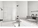Well-lit bathroom featuring a shower-tub combo, vanity with granite countertop, and modern fixtures for a luxurious experience at 244 Little Wilkesboro Rd, Harmony, NC 28634