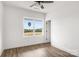 Bright bedroom featuring a large window with scenic views and modern wood-look floors, creating a serene space at 244 Little Wilkesboro Rd, Harmony, NC 28634