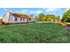 New construction home with exterior framing and roof in a neighborhood setting with green lawn and sunny skies at 244 Little Wilkesboro Rd, Harmony, NC 28634