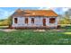 Image of new home construction showing exterior framing with house wrap, a roof, and a large green lawn at 244 Little Wilkesboro Rd, Harmony, NC 28634