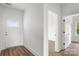 Inviting entryway featuring a bright white door and modern floors, leading to additional rooms and natural light at 244 Little Wilkesboro Rd, Harmony, NC 28634