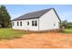 Exterior rear view of a newly constructed home with white siding, and a dark roof at 244 Little Wilkesboro Rd, Harmony, NC 28634