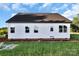 Back of new home construction, showcasing a dark roof, white siding, windows and a door with a grassy yard at 244 Little Wilkesboro Rd, Harmony, NC 28634