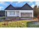 New construction home featuring a two-car garage and inviting front porch, all set in a verdant, spacious lot at 244 Little Wilkesboro Rd, Harmony, NC 28634