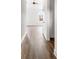 Bright hallway boasts wood-look floors leading to a window with views, creating a welcoming and spacious atmosphere at 244 Little Wilkesboro Rd, Harmony, NC 28634