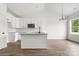 Modern kitchen featuring white cabinets, granite countertops, stainless steel appliances, and a stylish island at 244 Little Wilkesboro Rd, Harmony, NC 28634