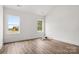 Bright living room featuring hardwood floors and multiple windows allowing ample natural light at 244 Little Wilkesboro Rd, Harmony, NC 28634