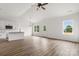 Spacious living room with hardwood floors, a ceiling fan, and a view of the kitchen and backyard at 244 Little Wilkesboro Rd, Harmony, NC 28634