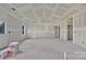 Open living room featuring bare drywall, large windows for ample sunlight, and high vaulted ceilings at 244 Little Wilkesboro Rd, Harmony, NC 28634