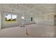 Spacious living room featuring large windows for ample sunlight, bare drywall, and high vaulted ceilings at 244 Little Wilkesboro Rd, Harmony, NC 28634