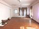 Large living room with hardwood floors and damaged walls at 32 Pinecrest Ave, Great Falls, SC 29055