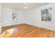 Well-lit bedroom with hardwood floors and two windows at 3401 Oak Tree Trl, Matthews, NC 28105