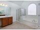 Main bathroom with double vanity, soaking tub, and shower at 3529 Cameron Creek Dr, Matthews, NC 28105