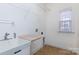 Laundry room with sink, built-in shelving, and window at 3529 Cameron Creek Dr, Matthews, NC 28105