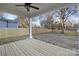 Covered deck overlooks fenced backyard with grass and mature trees at 4006 Avalon Ave, Charlotte, NC 28208