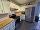 Modern kitchen with white cabinets and stainless steel appliances at 4020 Brandie Glen Rd, Charlotte, NC 28269