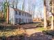 Two story gray house with red front door, brick chimney at 410 Lakenheath Ln, Matthews, NC 28105