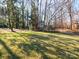 Spacious front yard with mature trees and a large grassy area at 410 Lakenheath Ln, Matthews, NC 28105