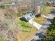 Aerial view of the home surrounded by trees, a well-manicured lawn, and a two-car garage at 412 Wildlife Rd, Troutman, NC 28166
