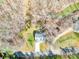 Aerial view of home showcasing mature landscaping, driveway, and backyard near a creek at 412 Wildlife Rd, Troutman, NC 28166