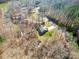 Aerial view of home showcasing mature landscaping, long driveway, and proximity to the lake at 412 Wildlife Rd, Troutman, NC 28166
