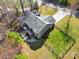 Aerial view features the home, surrounding fenced yard, and the private drive at 412 Wildlife Rd, Troutman, NC 28166