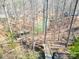An aerial view shows a lakeside boathouse and private dock with a walkway through the trees at 412 Wildlife Rd, Troutman, NC 28166
