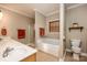 Relaxing bathroom with a soaking tub and double vanity at 412 Wildlife Rd, Troutman, NC 28166