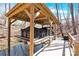 A covered boathouse features a boat lift and a serene waterfront setting at 412 Wildlife Rd, Troutman, NC 28166