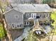 An elevated view of a charming two-story home featuring a spacious deck and stone accents at 412 Wildlife Rd, Troutman, NC 28166