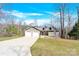 Charming home with a two-car garage, manicured lawn, and inviting front porch on a sunny day at 412 Wildlife Rd, Troutman, NC 28166