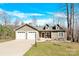 Charming home featuring a stone facade, dormers, and a two-car garage at 412 Wildlife Rd, Troutman, NC 28166