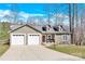 Charming home with a two-car garage, manicured lawn, and inviting front porch on a sunny day at 412 Wildlife Rd, Troutman, NC 28166