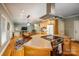 Open kitchen with island, stainless steel appliances, and hardwood floors at 412 Wildlife Rd, Troutman, NC 28166