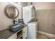 Convenient laundry room with stackable washer and dryer, plus a vanity with vessel sink at 412 Wildlife Rd, Troutman, NC 28166