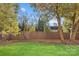 Private backyard with wooden fence and green grass at 5204 Sardis Rd, Charlotte, NC 28270