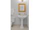 Powder room with pedestal sink, gold accents, and a tiled floor at 5204 Sardis Rd, Charlotte, NC 28270
