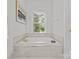 Relaxing bathroom with soaking tub and gold fixtures at 5204 Sardis Rd, Charlotte, NC 28270