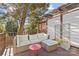 Relaxing deck with sectional sofa and red side table, wooded view at 5204 Sardis Rd, Charlotte, NC 28270