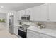 Stainless steel appliances and white shaker cabinets in this updated kitchen at 5204 Sardis Rd, Charlotte, NC 28270