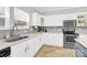 White kitchen with gray backsplash, granite counters, and stainless steel appliances at 5715 Hammermill Dr, Harrisburg, NC 28075