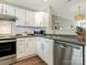 Modern kitchen with white cabinets, stainless steel appliances, and dark countertops at 7690 Petrea Ln, Charlotte, NC 28227