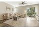 Living room with sectional sofa, coffee table, and sliding glass door to patio at 7690 Petrea Ln, Charlotte, NC 28227