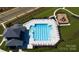 Community pool with adjacent playground and clubhouse at 8024 Kennesaw Dr, Gastonia, NC 28056