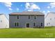 Rear exterior view of two-story home with gray siding and spacious backyard at 8024 Kennesaw Dr, Gastonia, NC 28056