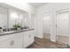 Bathroom with double sinks, white cabinetry, modern finishes, and walk-in shower at 8024 Kennesaw Dr, Gastonia, NC 28056