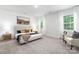 Neutral main bedroom features lots of light, sitting area, and contemporary decor at 8024 Kennesaw Dr, Gastonia, NC 28056