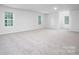 Spacious bonus room with neutral carpet and plenty of natural light from three windows at 8024 Kennesaw Dr, Gastonia, NC 28056